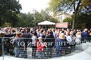 Throngs of people walk around the Virginia Women’s Monument in Capitol Square following Monday’s dedication ceremony. In addition to the bronze statues, the monument has a curved glass Wall of Honor etched with the names of 230 outstanding Virginia women who made contributions to the state and nation during the last 400 years.