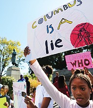 Kennedy Wright, 9, holds a sign protesting Columbus Day during a rally at the Columbus statue in Byrd Park on Monday. The protest, led by members of the Cultural Roots Homeschool Co-op, also urged removal of the statue that is situated at the south end of Arthur Ashe Boulevard. The protest was on Monday, Oct. 14, which had been designated by Richmond Mayor Levar M. Stoney as Indigenous Peoples’ Day to honor the contributions native people who were displaced and destroyed as a result of European invasion by people such as Christopher Columbus. The home school cooperative has a curriculum that emphasizes the black diaspora including Caribbean, Central and South/ North America’s indigenous peoples.(Regina H. Boone/Richmond Free Press)