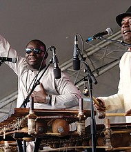 Lots of music, lots of folk/Richmond’s Downtown riverfront came alive with people and music last weekend as thousands of people turned out for the Richmond Folk Festival. Balla Kouyaté of Mali and Famoro Dioubaté from Guinea, balafon masters, treat the audience to their modern and inventive sounds on an ancient instrument. (Sandra Sellars/Richmond Free Press)