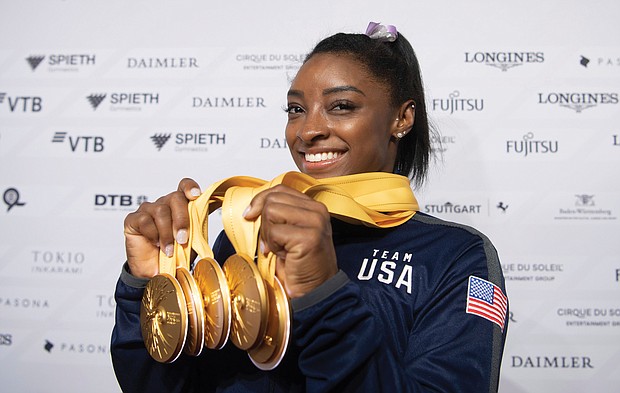 U.S. gymnast Simone Biles shows off the five gold medals she won at the Gymnastics World Championships in Stuttgart, Germany, making her the world’s most decorated gymnast with a cumulative 25 medals.