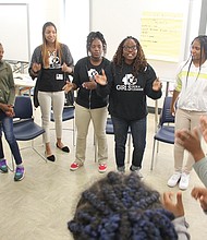 Eighth-graders at Martin Luther King Jr. Middle School participate in the kick off of the new mentoring program with leaders Angela Patton, chief executive officer of Girls for a Change, second from right; Anna Gage, Girl Action Team coordinator, third from right; and Virginia Commonwealth University intern Tiffany Fox, fourth from right.