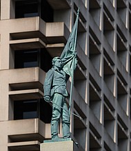 A statue of a Confederate soldier nicknamed “Johnny Reb” stands as part of an 80-foot-tall Confederate monument in downtown Norfolk. The City of Norfolk filed suit in August in federal court targeting a Virginia law that prevents the removal of war memorials.