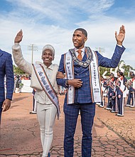 Miss VSU Dayana Lee of Virginia Beach and Mr. VSU Fredricks Sanders of Charlotte, N.C., wave to the homecoming crowd as they are introduced with the royal court.