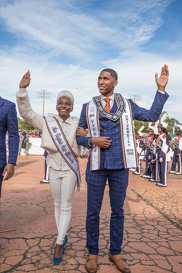 Miss VSU Dayana Lee of Virginia Beach and Mr. VSU Fredricks Sanders of Charlotte, N.C., wave to the homecoming crowd as they are introduced with the royal court.