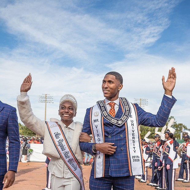 Miss VSU Dayana Lee of Virginia Beach and Mr. VSU Fredricks Sanders of Charlotte, N.C., wave to the homecoming crowd as they are introduced with the royal court.