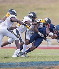 Virginia State University quarterback Cordelral Cook makes an 8-yard run across the goal line during the first quarter, giving the Trojans a 7-0 lead over the Bowie State Bulldogs in last Saturday’s homecoming game. The Trojans lost the game 24-14.