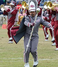 Diamond McGhee, one of two drum majors with the VUU Ambassadors of Sound Marching Band, takes charge during the halftime show at Hovey Field.