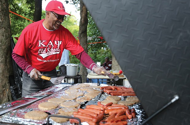 Westley Steele, a member of Kappa Alpha Psi Fraternity, works the grill in preparation for a lot of hungry tailgaters.