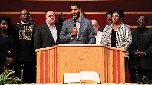 The Rev. Otis Moss III, center, is surrounded by other Chicago church leaders and denomination officials with the United Church of Christ to announce on Oct. 20 that the group paid off $5.3 million in medical debt for poor people in Illinois.