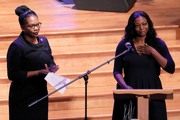 Jennifer Cummings, left, applauds in response to remarks by her sister, Adia Cummings, during the funeral of their father, Rep. Cummings.