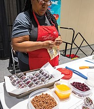 The Greater Richmond Convention Center was the first stop last Saturday for the 4th Annual “Spirit of the Heart” tour sponsored by the Association of Black Cardiologists Inc., a Washington-based organization dedicated to eliminating disparities in cardiovascular disease in people of color.
The event featured a health and wellness fair, free heart health and other screenings, health information from community-based organizations fitness and nutrition experts and health-related activities for seniors and children.
Dr. Phillip Duncan, a Richmond area cardiologist and association member, was a local host of the event, along with Saint Paul’s Baptist Church, Virginia Union University and other ABC members.
The Spirit of the Heart tour will continue in Atlanta, Chicago, New York City, San Francisco, and Orange County, California.
In this photo, Sequoia Ross, owner of Favour Cookie Company, prepares a vegan cooking demonstrations at the health and wellness fair, including individual tasting containers of her quinoa, beet and cilantro salad.