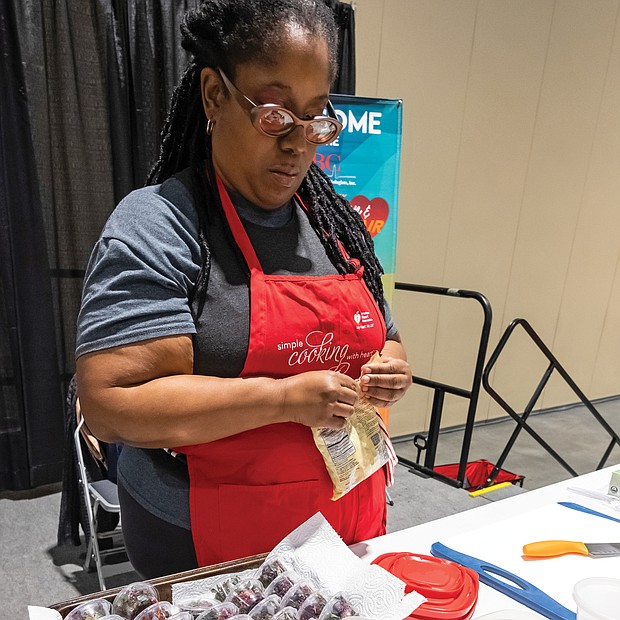 The Greater Richmond Convention Center was the first stop last Saturday for the 4th Annual “Spirit of the Heart” tour sponsored by the Association of Black Cardiologists Inc., a Washington-based organization dedicated to eliminating disparities in cardiovascular disease in people of color.
The event featured a health and wellness fair, free heart health and other screenings, health information from community-based organizations fitness and nutrition experts and health-related activities for seniors and children.
Dr. Phillip Duncan, a Richmond area cardiologist and association member, was a local host of the event, along with Saint Paul’s Baptist Church, Virginia Union University and other ABC members.
The Spirit of the Heart tour will continue in Atlanta, Chicago, New York City, San Francisco, and Orange County, California.
In this photo, Sequoia Ross, owner of Favour Cookie Company, prepares a vegan cooking demonstrations at the health and wellness fair, including individual tasting containers of her quinoa, beet and cilantro salad.