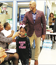 Damon E. Duncan, president and chief executive officer of the Richmond Redevelopment and Housing Authority, greets Richmond Delegate Delores L. McQuinn in the Creighton Court Community Center as tenants of the public housing community meet Monday to discuss the recent evictions.