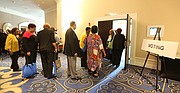 Delegates line up to cast ballots for state officers last Saturday at the Virginia State Conference NAACP’s 84th convention. Forty-eight delegates were disqualified from voting, along with two of the five candidates for state president.