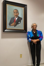 Ann Walker, widow of civil rights icon Dr. Wyatt Tee Walker, with the portrait of her late husband during Monday’s ceremony at Virginia Union University.