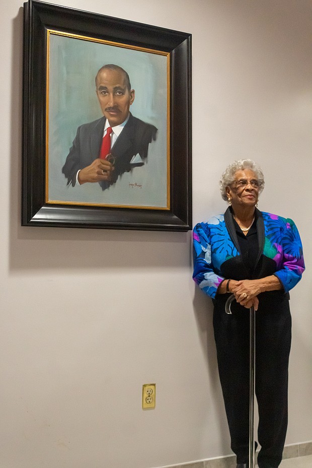 Ann Walker, widow of civil rights icon Dr. Wyatt Tee Walker, with the portrait of her late husband during Monday’s ceremony at Virginia Union University.