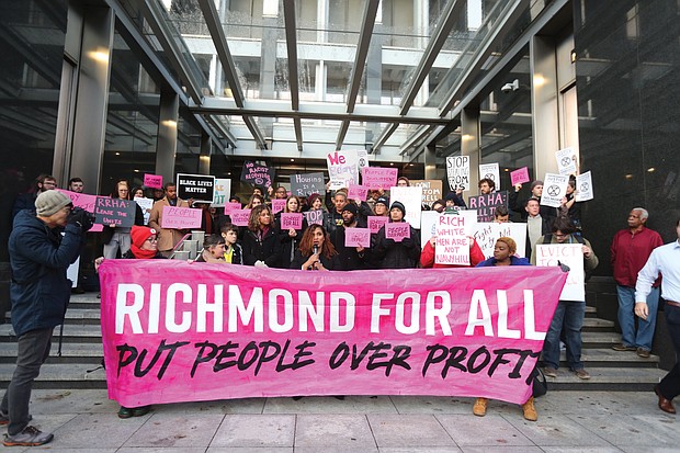 Richmond City Councilwoman Kim Gray, 2nd District, center, joins housing and environmental justice advocates during a rally Tuesday outside City Hall organized by Richmond For All. The group voiced their opposition to the Navy Hill District Corp’s proposed Coliseum replacement project and evictions and displacement of people from Richmond public housing.