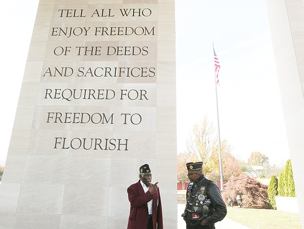 Retired Army Maj. Willie A. Taylor of Richmond talks with decorated retired Army veteran Sammy Granderson of Fredericksburg about a late friend whose name is now engraved on a wall at the memorial.