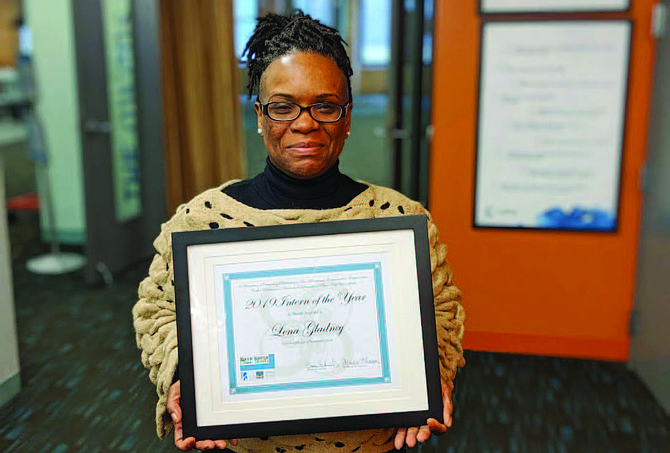 Lena Gladney proudly holds up a plaque she received after being named “2019 Intern of the Year” by the nonprofit Cleanslate. Photo credit: By Wendell Hutson