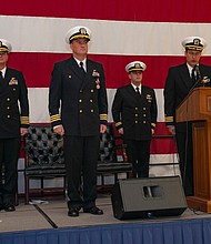 Cmdr. William M. Mathis (second from left) turns over 
command of VFA-34 to Cmdr. Juston R. Kuch (far right)
during change of command ceremony.