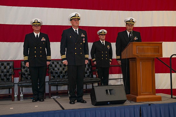 Cmdr. William M. Mathis (second from left) turns over 
command of VFA-34 to Cmdr. Juston R. Kuch (far right)
during change of command ceremony.