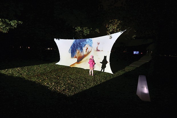 A youngster is intrigued by her shadow on an art installation at Chimborazo Park last Friday and Saturday as part of 1708 Gallery’s InLight 2019, an annual exhibition of light-based art and performances. About 20 pieces were at the free, two-day, outdoor exhibit in Church Hill focused on the social and geographic history of the park, which served as one of the largest Confederate military hospitals during the Civil War and afterward a community for formerly enslaved people. The installation the youngster enjoyed is “Pieces of Us” by Allicette Torres.
