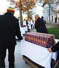 Dr. Kevin Allison, who has led the East Marshall Street Well Project for Virginia Commonwealth University, and first-year medical student Gerald Coronado transfer the remains for the ceremony at the sciences building.