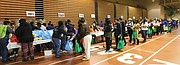 Because of the volunteer effort, hundreds of people moved smoothly through the line at the Arthur Ashe Jr. Athletic Center to take home turkeys, canned goods and the trimmings for Thanksgiving.