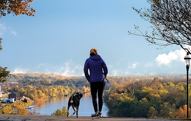 A woman and her dog pause to drink in an iconic view of the James River from Libby Hill Park in the East End. Legend has it that the city’s founder, William Byrd II, named Richmond after the English borough of Richmond-upon-Thames because the bend of the James River at this vantage point reminded him of the Thames River in its passage through that London suburb. No evidence has ever turned up to support the story.