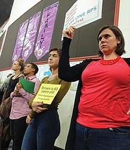 Parents hold signs at the Richmond school rezoning public hearing Monday night at Bellevue Elementary School signifying their support for school integration and diversity, along with a desire that the money needed to pair schools to achieve diversity be used to boost student instruction.