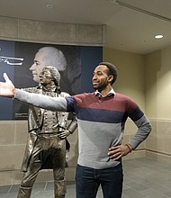 Cast members from the Richmond tour of “Hamilton” get a behind-the- scenes tour of the Virginia Museum of History & Culture last Friday where they had an opportunity to see historical artifacts related to the characters they portray. Edred Utomi, who portrays the musical’s name character, Alexander Hamilton, strikes a pose immortalized by the museum’s Hamilton sculpture in the infamous duel with Aaron Burr.