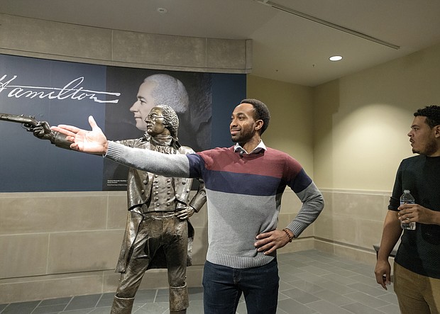 Cast members from the Richmond tour of “Hamilton” get a behind-the- scenes tour of the Virginia Museum of History & Culture last Friday where they had an opportunity to see historical artifacts related to the characters they portray. Edred Utomi, who portrays the musical’s name character, Alexander Hamilton, strikes a pose immortalized by the museum’s Hamilton sculpture in the infamous duel with Aaron Burr.