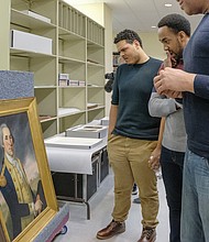 Tyler Belo, who portrays James Madison, views a portrait of Washington in the museum’s vault. Virginia was a focal point for much of the activity and many of the “Founding Fathers” involved in the creation of a new nation, with artifacts and other historical objects located in collections in the state.