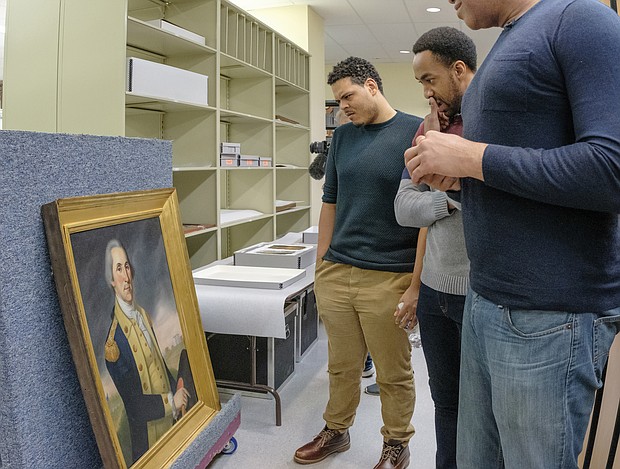 Tyler Belo, who portrays James Madison, views a portrait of Washington in the museum’s vault. Virginia was a focal point for much of the activity and many of the “Founding Fathers” involved in the creation of a new nation, with artifacts and other historical objects located in collections in the state.