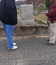 Charles S. Vaughan, left, and Eddie Radden Jr. view improvements at the historically black Mount Olivet Cemetery in South Side for which they have lobbied City Hall for several years.
“It’s looking much better,” Mr. Vaughan said last Saturday in praising the city cemetery management for pruning bushes, trimming trees, removing grass covering name plates and tidying the burial ground.
Mount Olivet Cemetery, located off Hopkins Road, dates to 1874 and is part of the larger, historically white Maury Cemetery that the city also owns.
The two retirees are regular visitors to Mount Olivet, the final resting place of some of the most prominent African-Americans in South Side. Here, they pause in front of the grave of the Rev. Anthony Binga Jr., a top South Side educator of black children, a celebrated pastor for 47 years of First Baptist Church of South Richmond and a leader in national black Baptist groups before his death in 1919.