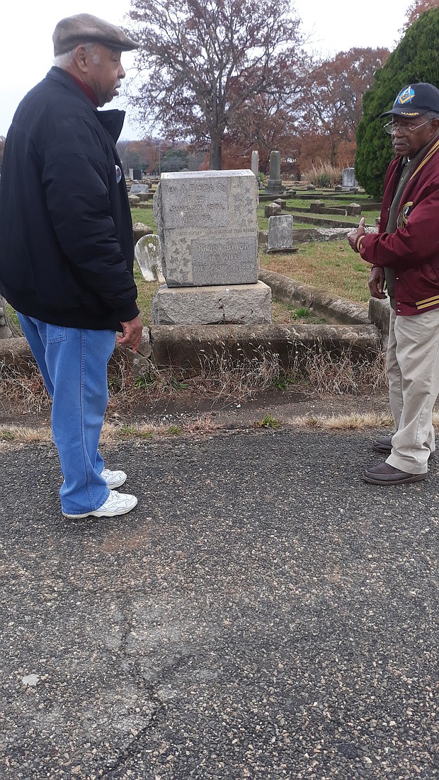 Charles S. Vaughan, left, and Eddie Radden Jr. view improvements at the historically black Mount Olivet Cemetery in South Side for which they have lobbied City Hall for several years.
“It’s looking much better,” Mr. Vaughan said last Saturday in praising the city cemetery management for pruning bushes, trimming trees, removing grass covering name plates and tidying the burial ground.
Mount Olivet Cemetery, located off Hopkins Road, dates to 1874 and is part of the larger, historically white Maury Cemetery that the city also owns.
The two retirees are regular visitors to Mount Olivet, the final resting place of some of the most prominent African-Americans in South Side. Here, they pause in front of the grave of the Rev. Anthony Binga Jr., a top South Side educator of black children, a celebrated pastor for 47 years of First Baptist Church of South Richmond and a leader in national black Baptist groups before his death in 1919.