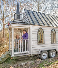 Donald McWilliams Jr. and Roberta Jennings recreate their engagement pose on the landing of the 100-square-foot tiny chapel where they will become husband and wife before the Richmond Christmas Parade on Saturday, Dec. 7.