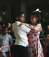 Classmates Jeremiah Crews and Valerie Velasco-Fuentes take their opening stances as they begin a dance performance for parents, teachers and schoolmates last month at Southampton Elementary School. The students were part of Dancing Classrooms Greater Richmond, a nonprofit program that uses ballroom dance to teach youngsters social awareness and build self-esteem. Teams from various schools competed Wednesday night at Huguenot High School in “Colors of the Rainbow,” a match between fifth-grade teams from six schools in the Richmond area.