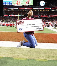 “Destiny Alfred secured $100,000 in free tuition after competing in the Dr Pepper Tuition Giveaway during the halftime of the PAC 12 Conference Championship (Photo Credit: Dr Pepper)”