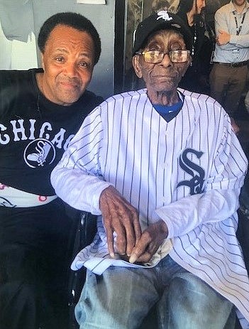 (from left) Andrew Holmes, a South Side community activist, surprised CP Crawford on his
112th birthday in August with tickets for him to attend his first Chicago White Sox game.
Photo credit: Courtesy of Andrew Holmes