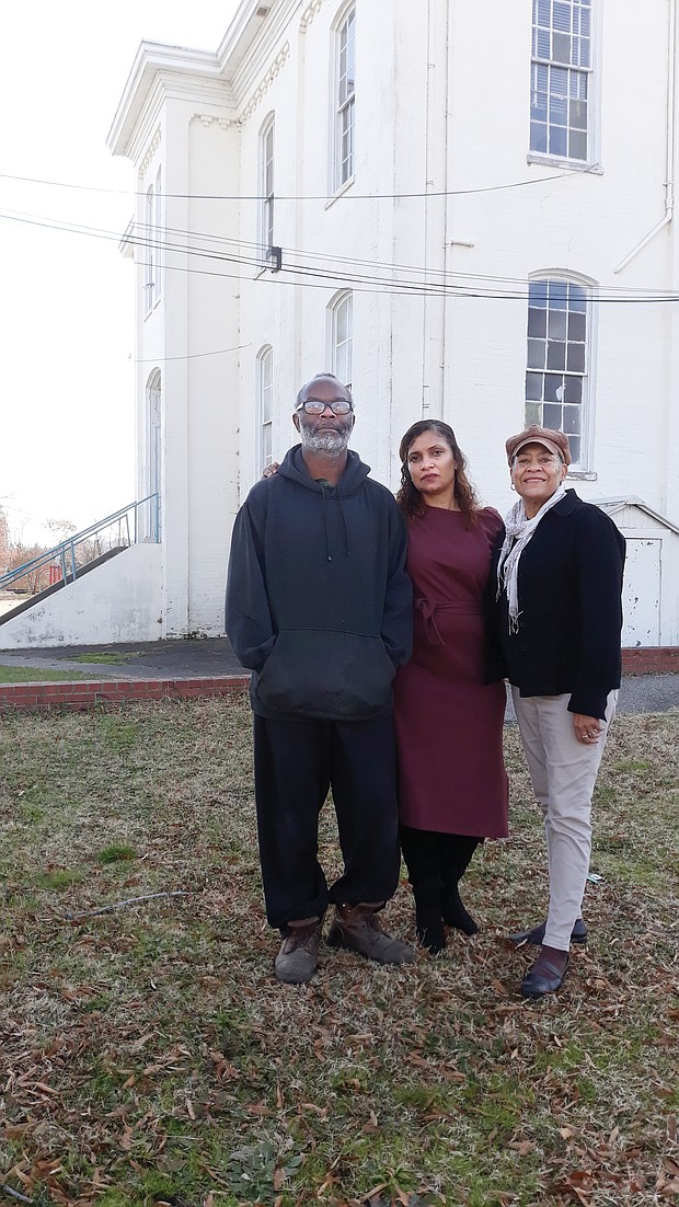 Jerome Legions, president of the Carver Area Civic Improvement League, stands with 2nd District City Councilwoman Kim B. Gray, center, and past civic league president Charleen Baylor outside the vacant Moore Street School in the Carver neighborhood.