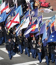 Students from Richmond’s Franklin Military Academy parade with a colorful array of flags