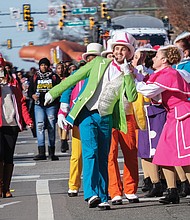 Performers from Kings Dominion entertain spectators as they march along the route.