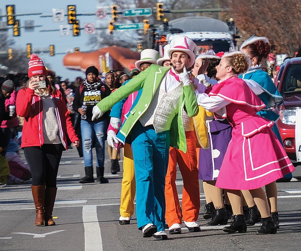 Performers from Kings Dominion entertain spectators as they march along the route.