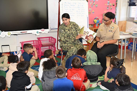 NRD San Antonio’s Assistant Command Career Counselor, Personnel Specialist 1st Class Kamitria Delaney, right, of Houston, reads to a first …