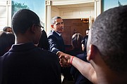 President Obama greets and takes a photo with students from Johnson Preparatory School of Chicago in the Diplomatic Room of the White House in October 2011.