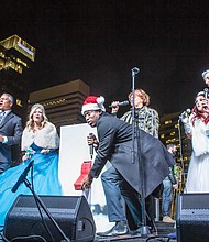 Mayor Levar M. Stoney is poised during the countdown to flip the giant switch to light up the city’s skyline.