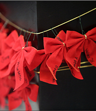 Participants wrote the names of their loved ones on red ribbons that were placed around the statue, “River of Tears,” that stands situated in City Hall.