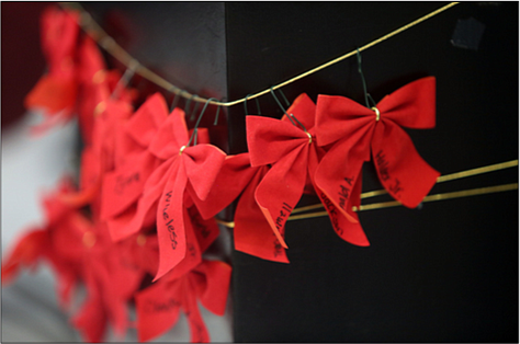 Participants wrote the names of their loved ones on red ribbons that were placed around the statue, “River of Tears,” that stands situated in City Hall.