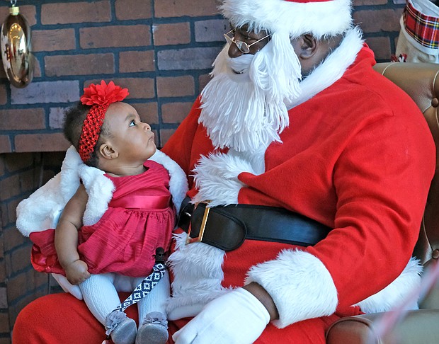 Ayla Hyndman, 6 months, is giving Soul Santa a close examination as if to determine if she can tell him all of her Christmas wishes. This is the first Christmas for Ayla, who visited Soul Santa, aka Floyd Brown, recently with her parents at the Black History Museum and Cultural Center of Virginia. Soul Santa has become an annual tradition at the museum in Jackson Ward.